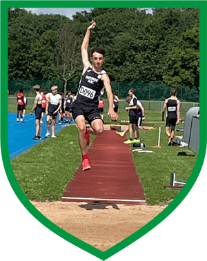 Teenage boy doing long jump in Deeside